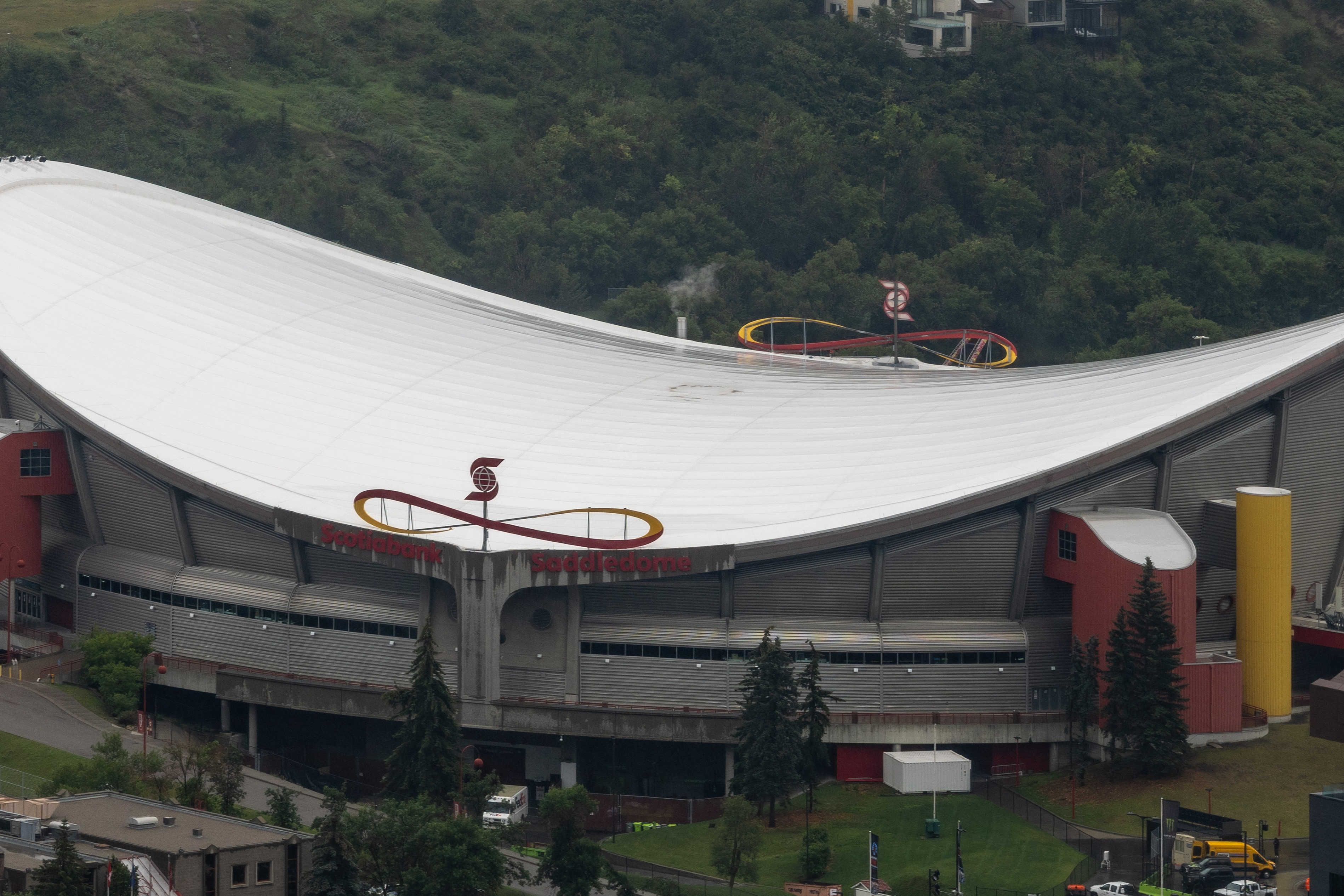 Aerial view of the Scotiabank Saddledome's saddle-shaped roof from Calgary Tower, high at both ends and dipping in the middle.