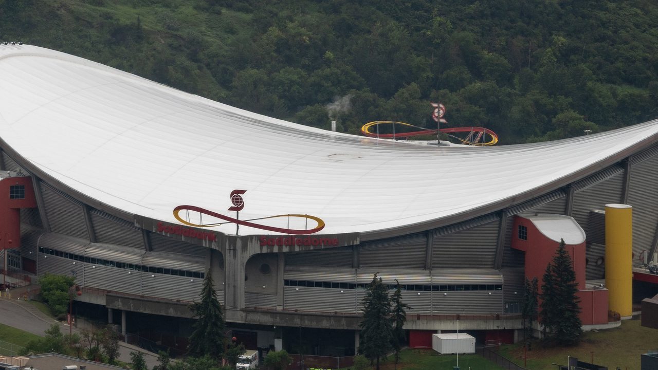 Aerial view of the Scotiabank Saddledome's saddle-shaped roof from Calgary Tower, high at both ends and dipping in the middle.
